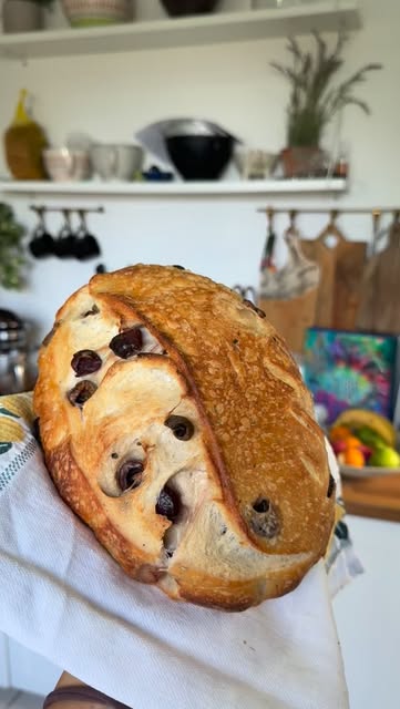 A freshly baked olive sourdough loaf from Sourdough DXB