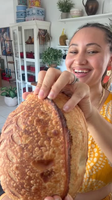 Tracey in her kitchen with a freshly baked sourdough loaf